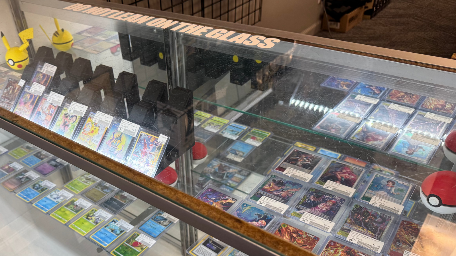 pokemon cards displayed in glass case at 8-Bit Legends pokemon card store in Jonesboro Arkansas