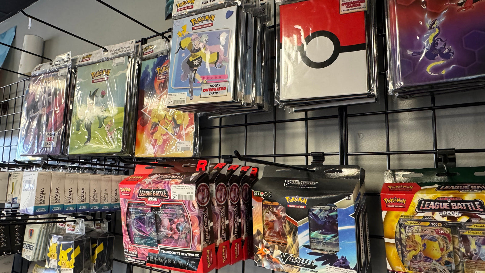 Pokémon trading card game products including booster packs and league battle decks on display at 8-Bit Legends Video Games in Jonesboro Arkansas