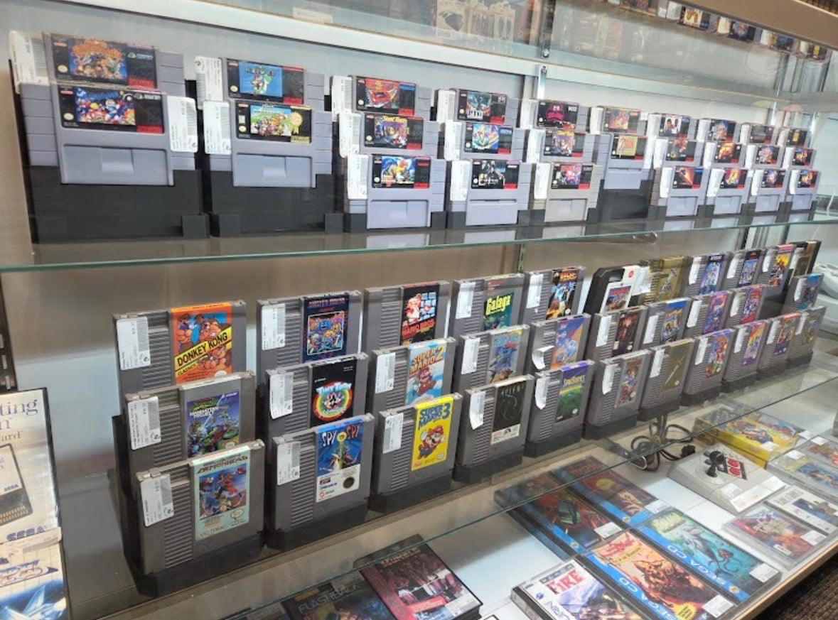 retro nes and super nintendo games displayed in case at 8-Bit Legends retro video game store in Jonesboro Arkansas